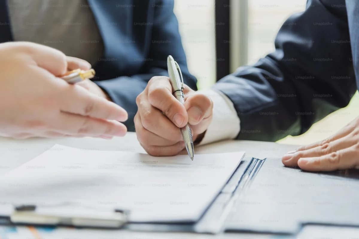 Business executives reviewing contract terms, intellectual property clauses, and service guarantees