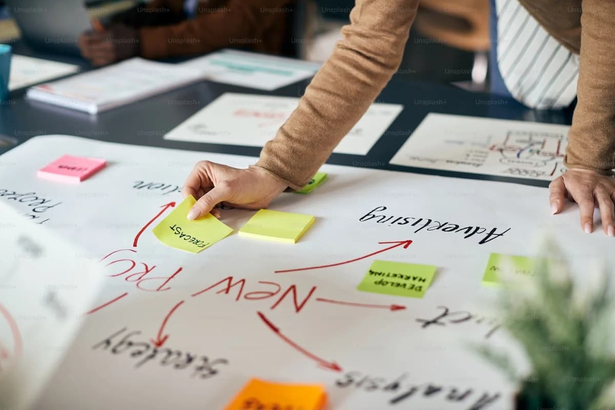 Information architect planning URL hierarchy and taxonomy relationships on whiteboard