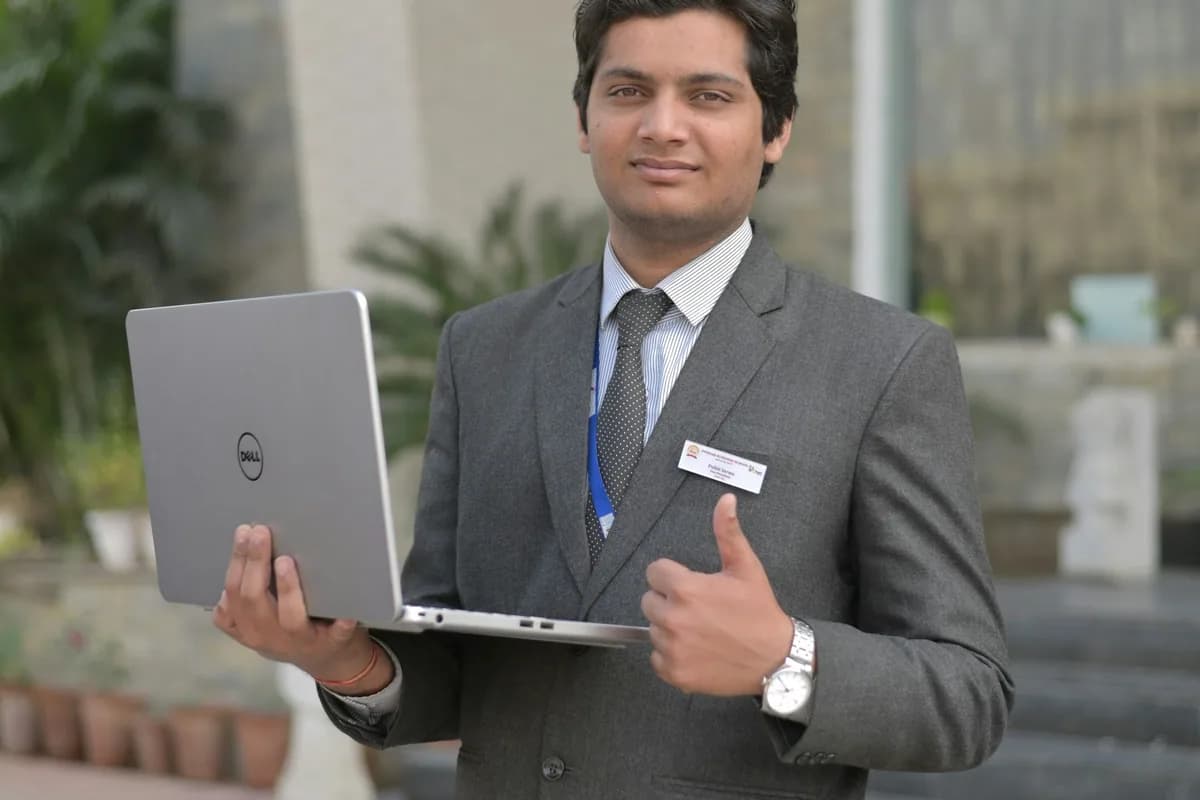 Indian enterprise CRM consultant in business suit presenting pipeline automation architecture on laptop